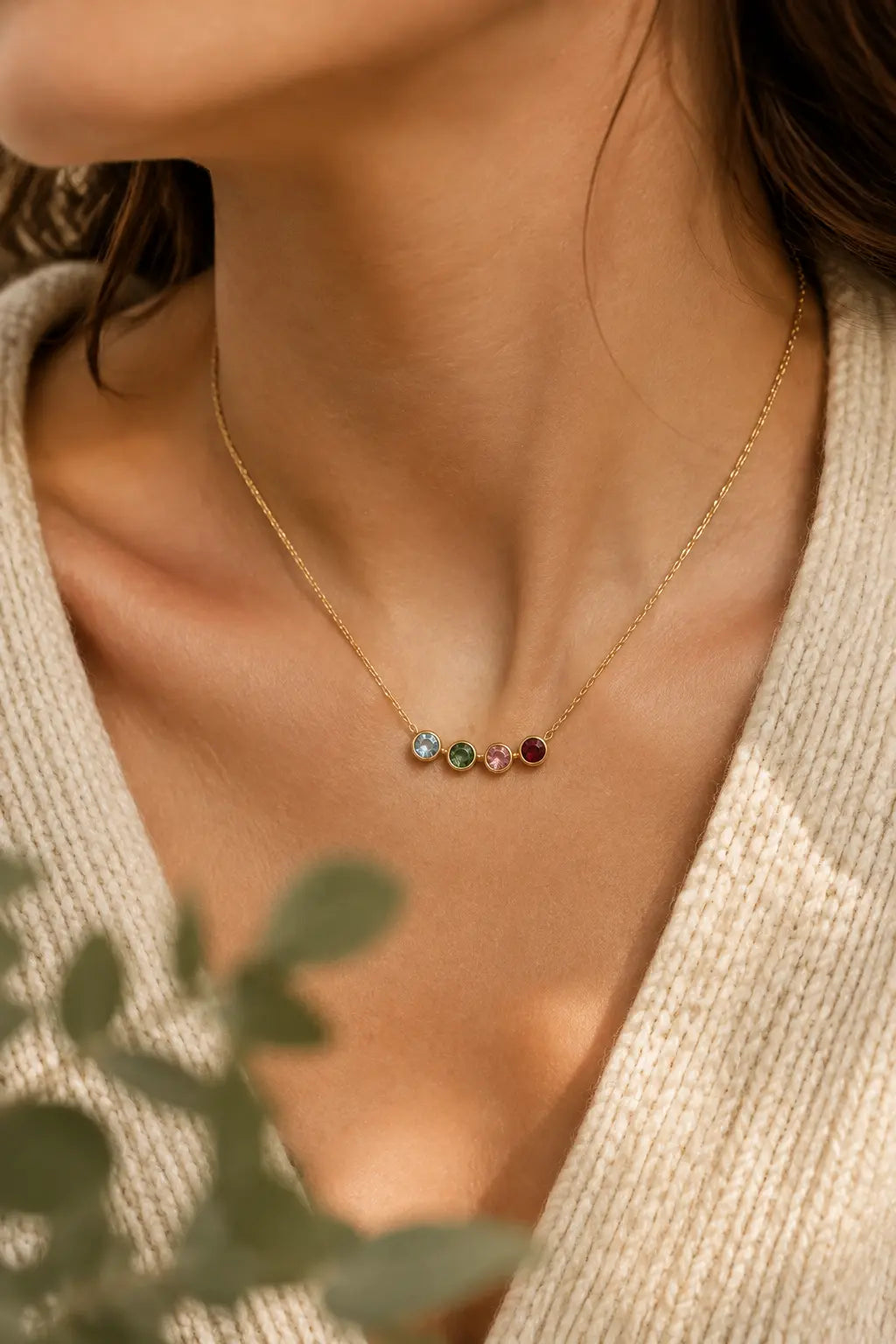 Four birthstones worn on a delicate necklace